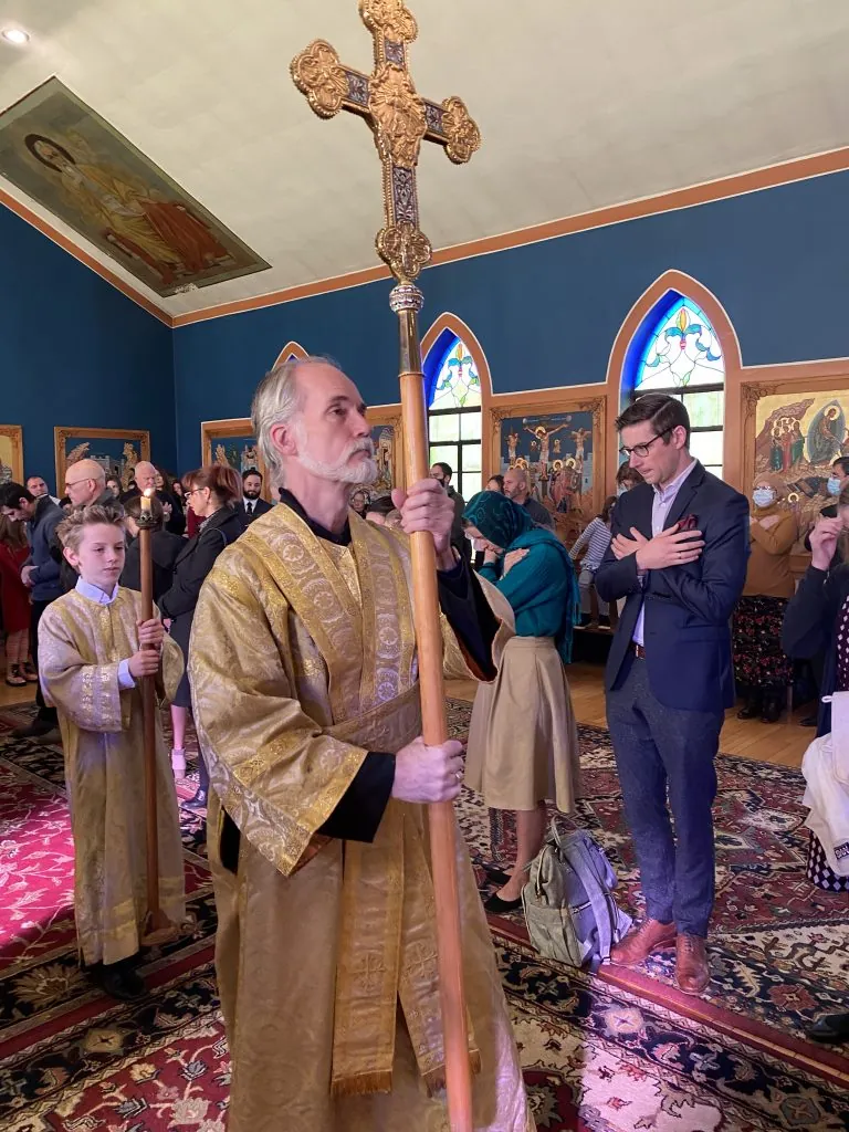 Subdeacon Frank Weiner carrying a candle during worship
