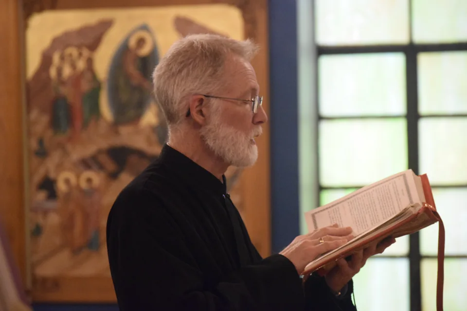 A parish reader chanting from an open service book
