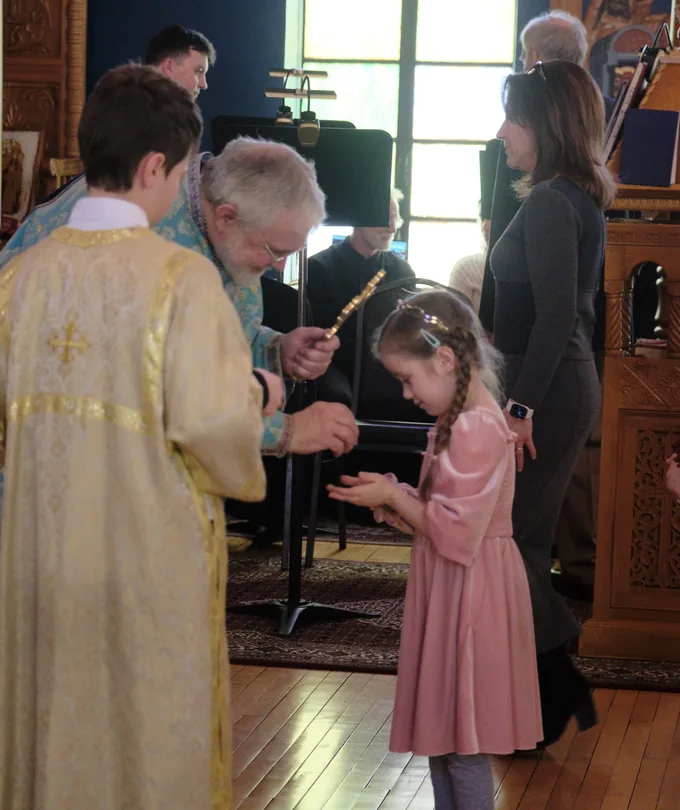 A child receiving Communion during a parish service